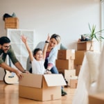 carefree family having fun while moving into new home