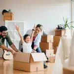 carefree family having fun while moving into new home