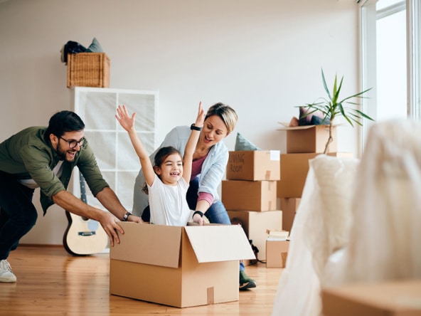 carefree family having fun while moving into new home